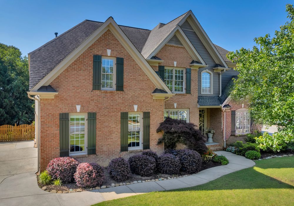 Two-story brick home exterior with landscaped front yard
